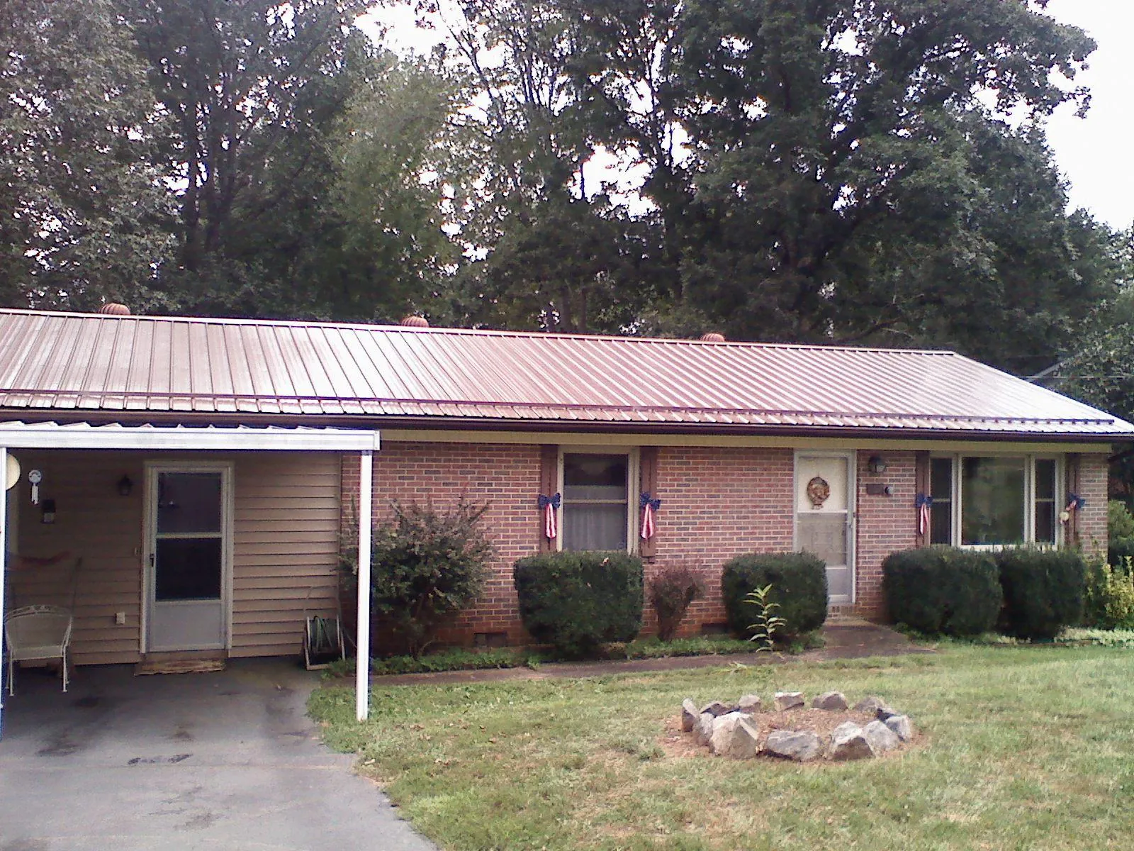 Bronze metal roof and carport on a brick ranch home — Roof Repair work by our crew in Annville